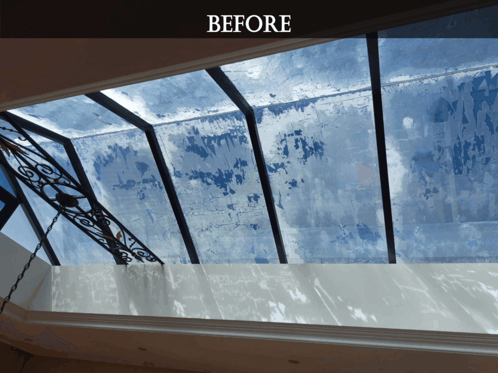 Before renovation, residential skylight in the living room showing peeling paint on glass panels.