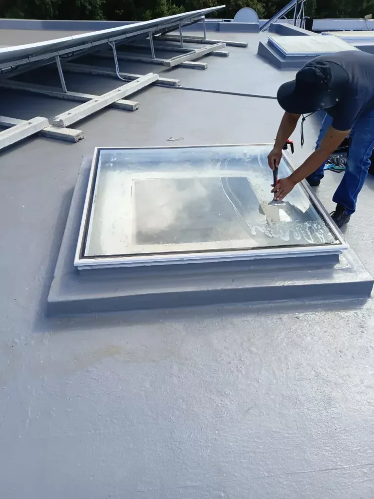 Old window tint removal from roof skylight using scraper during professional glass restoration